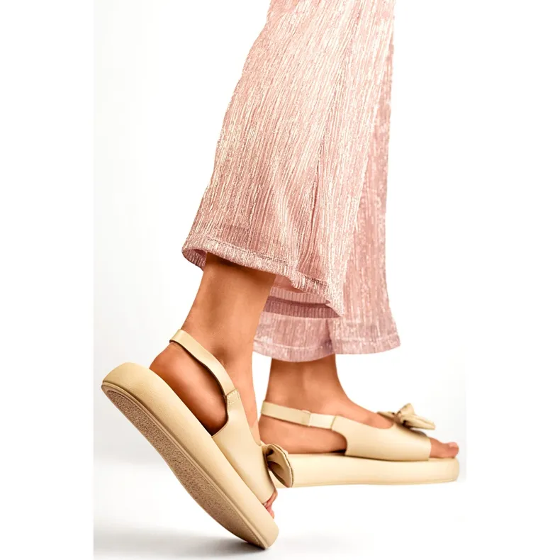 Beige women's platform sandals with a teddy bear bow